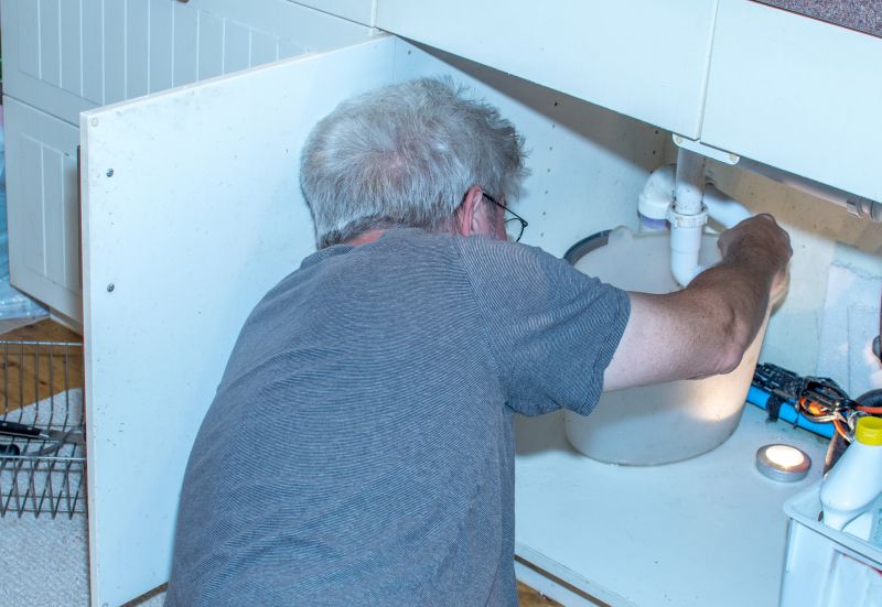 Handyman Fixing a Leaky Pipe